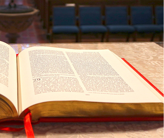 An open bible lying a table
