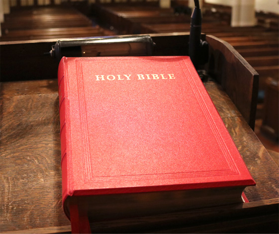 The Holy Bible closed on a desk